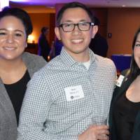 Three alumni pose for a photo together at the Chicago Reception